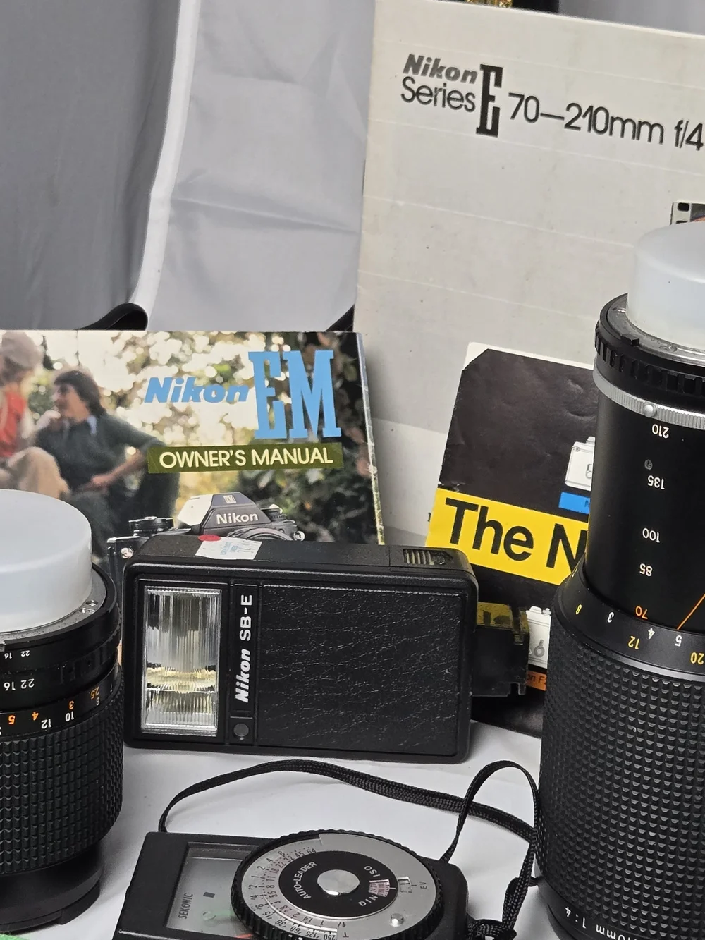 Nikon EM 35mm Film Camera Kit with 28mm, 50mm, 70-210mm Series E Lenses, SB-E Fl